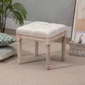 Ottoman carré beige avec assise capitonnée et pieds sculptés, simple