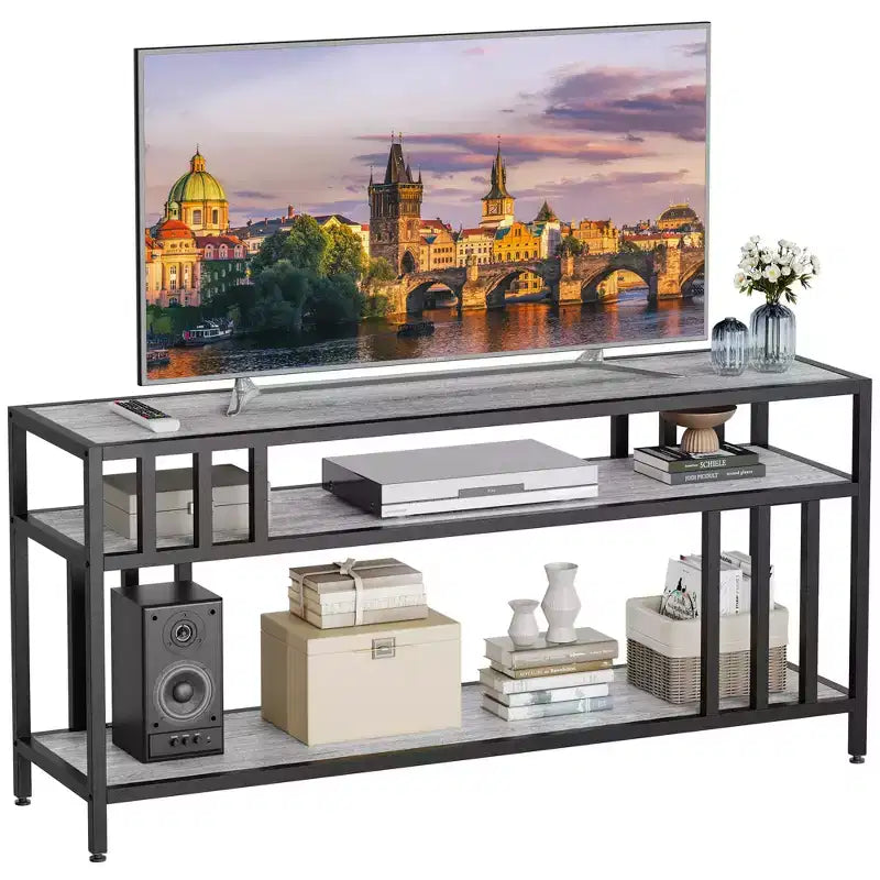 TV stand compatible with TVs up to 75 inches. Three-tier open shelving media cabinet. Industrial-style entertainment center for the living room.